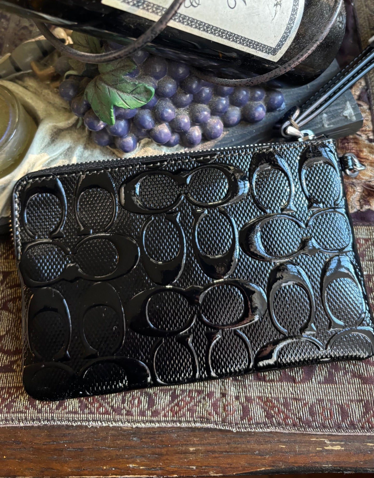 Authentic COACH patent signature leather zip top wristlet with a heart charm 
New with tags - Ruby Luxury
