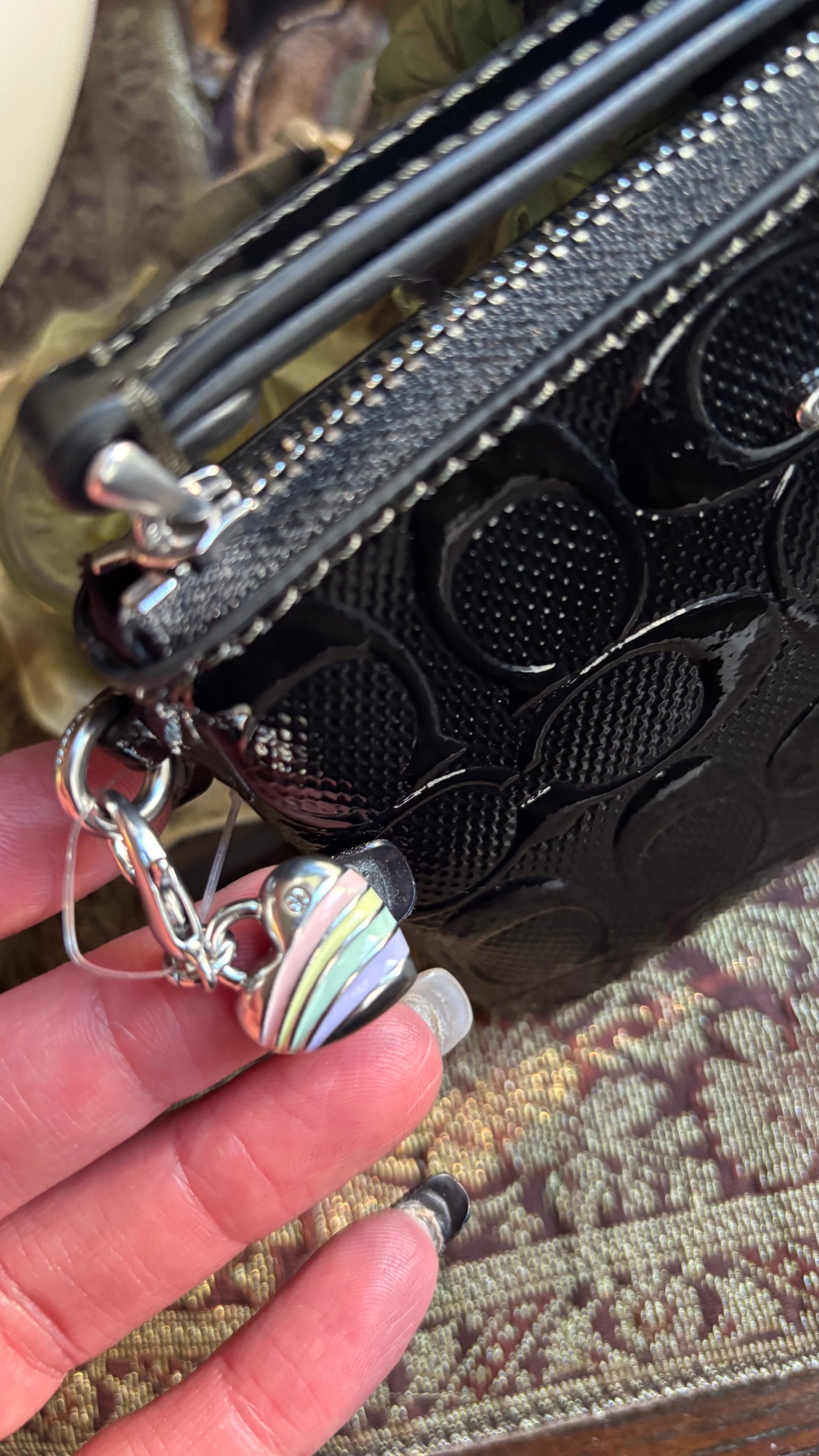 Authentic COACH patent signature leather zip top wristlet with a heart charm 
New with tags - Ruby Luxury