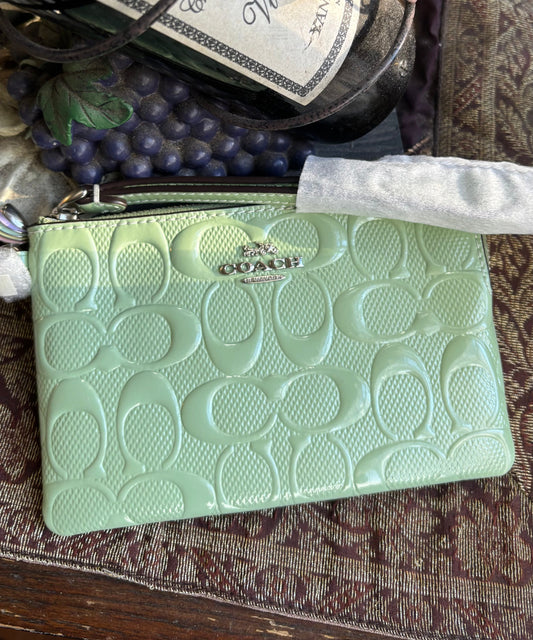 Authentic COACH patent signature leather zip top wristlet with a heart charm  New with tags - Ruby Luxury